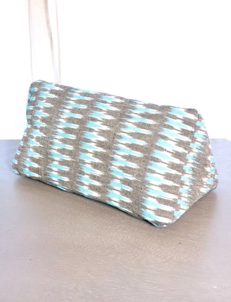 Grey and teal ikat cotton toiletry bag, patterned design.