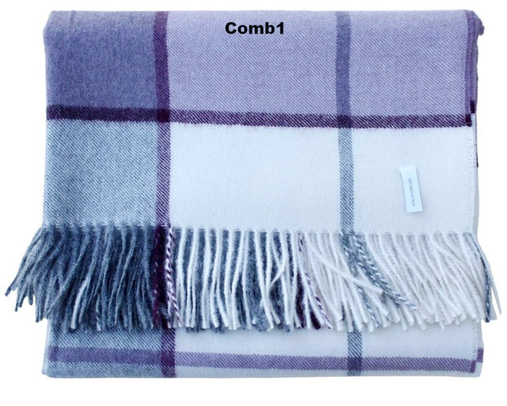 Plaid blanket with blue and white check pattern and fringes on a white background