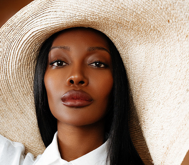 The Grand Belmont natural straw sun hat with a wide, snap-or-floppy brim.