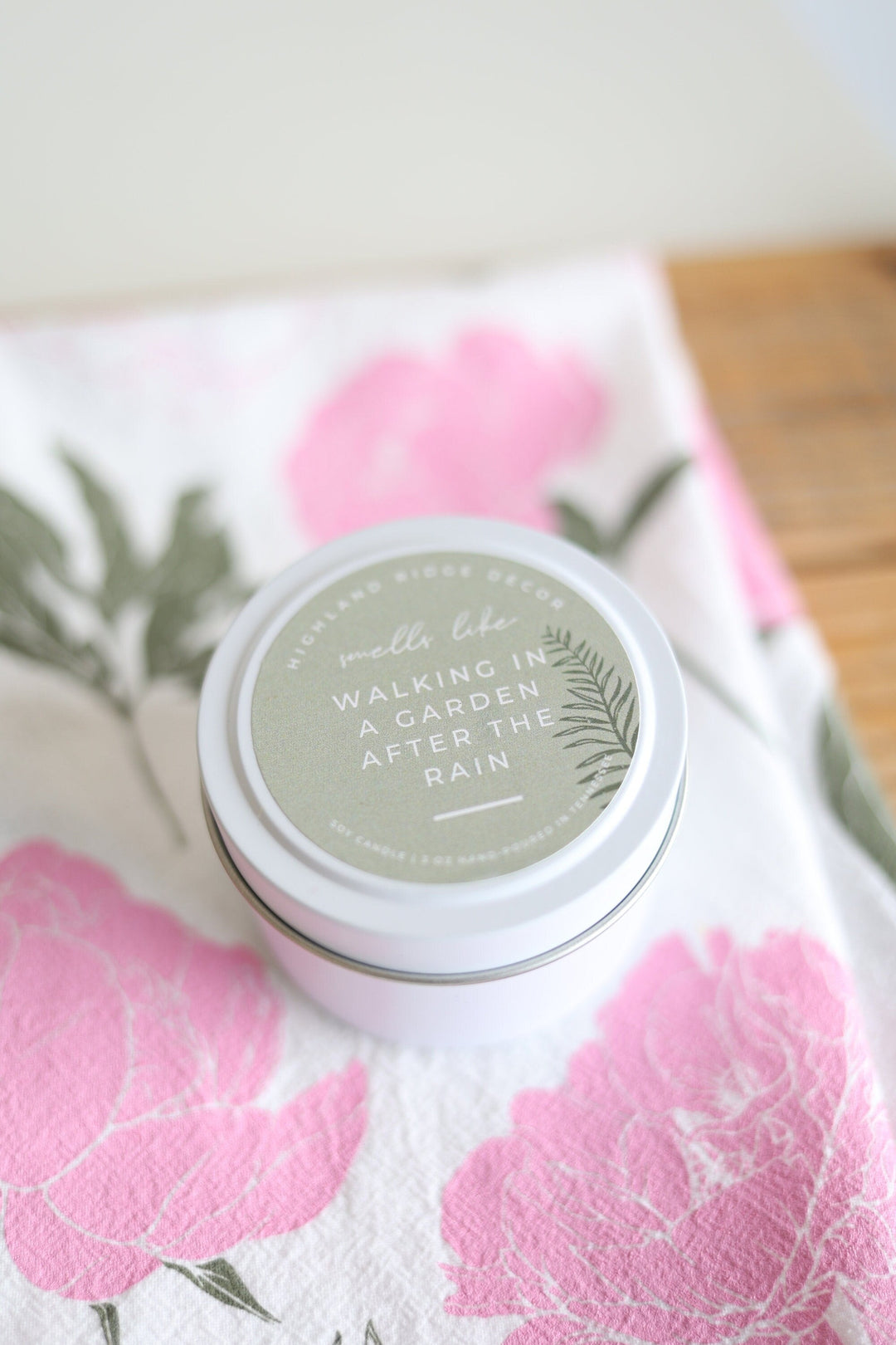 Hand-poured soy Garden Rain candle in a decorative tin.