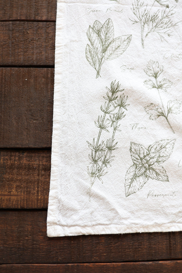 Kitchen herbs tea towel with a green watercolor botanical design.