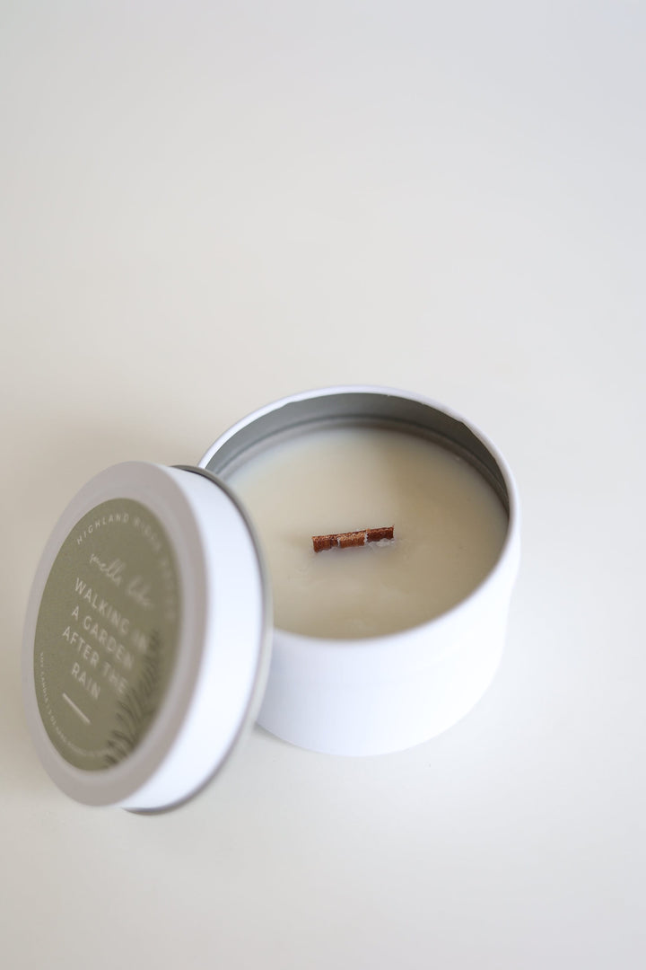 Garden Rain soy candle in a tin with a floral label.