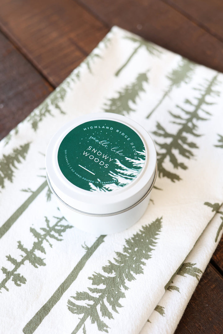 Snowy Woods soy candle with a wooden wick and winter woodland label.