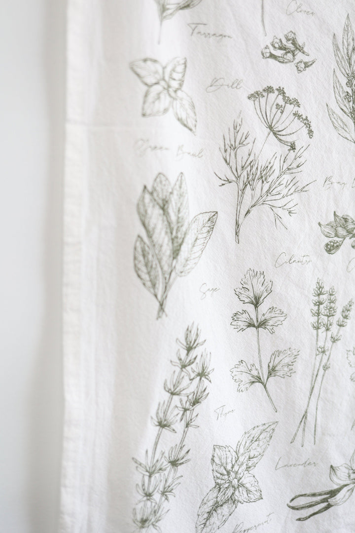 Kitchen herbs tea towel with a soft watercolor herb design in green on cotton.