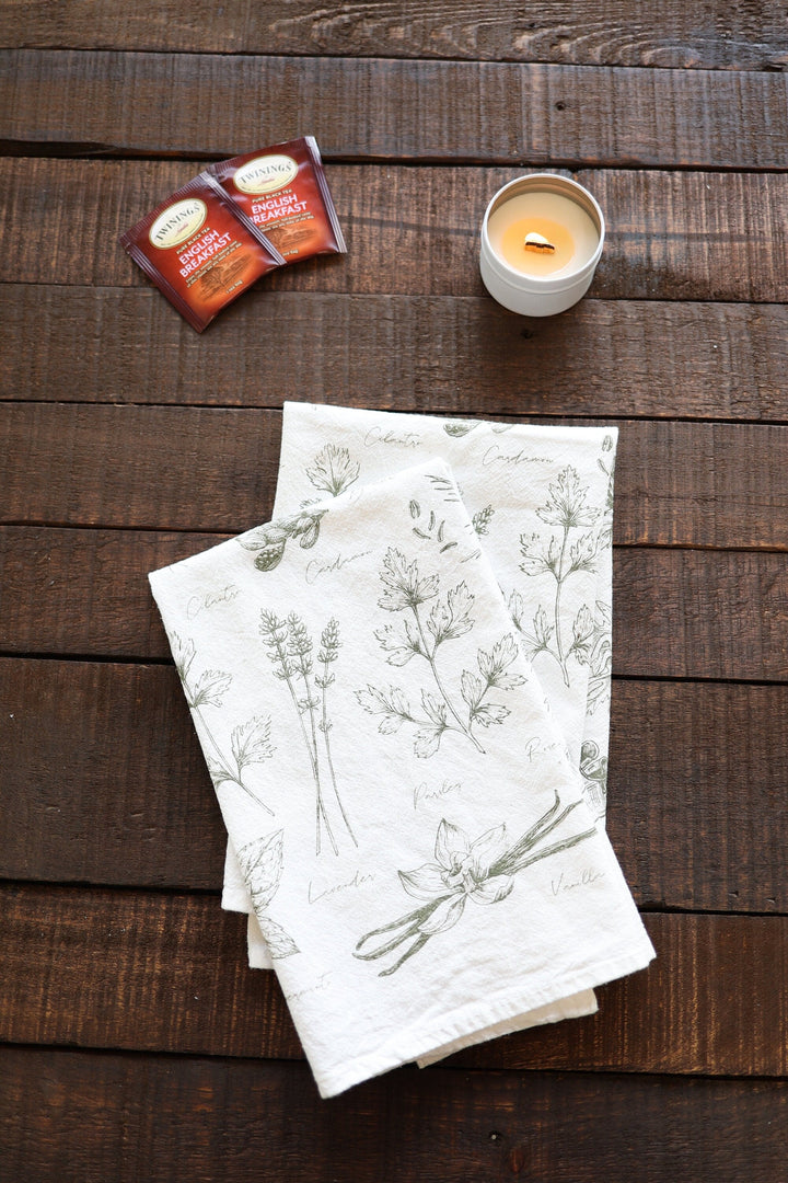 Kitchen herbs tea towel with watercolor herb illustrations on soft cotton.