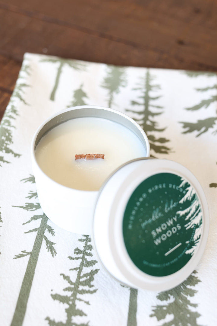 Snowy Woods soy candle tin with a winter woodland label.