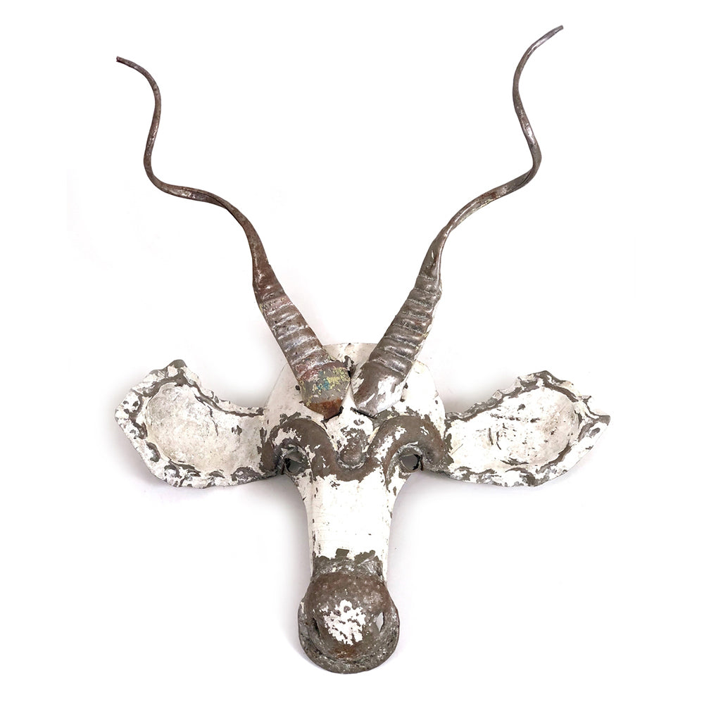 Recycled metal kudu antelope mask with its distinctive spiraling horns.