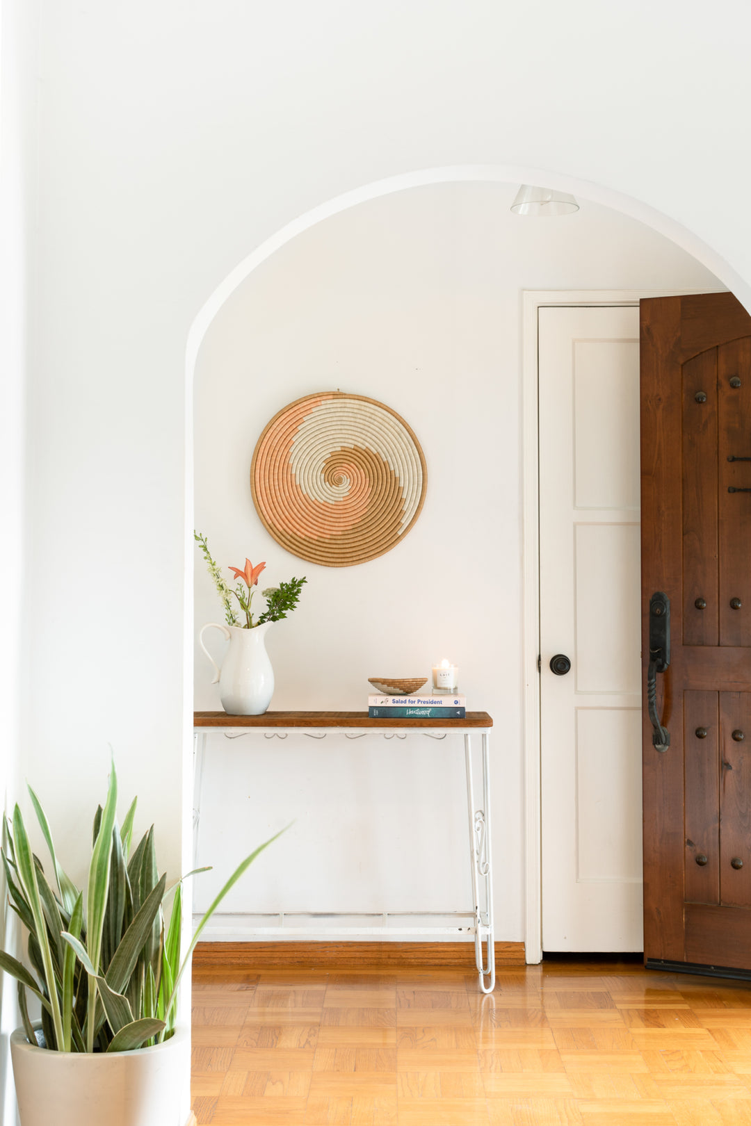 Flat woven sisal wall hanging in white and tea with a textured weave.