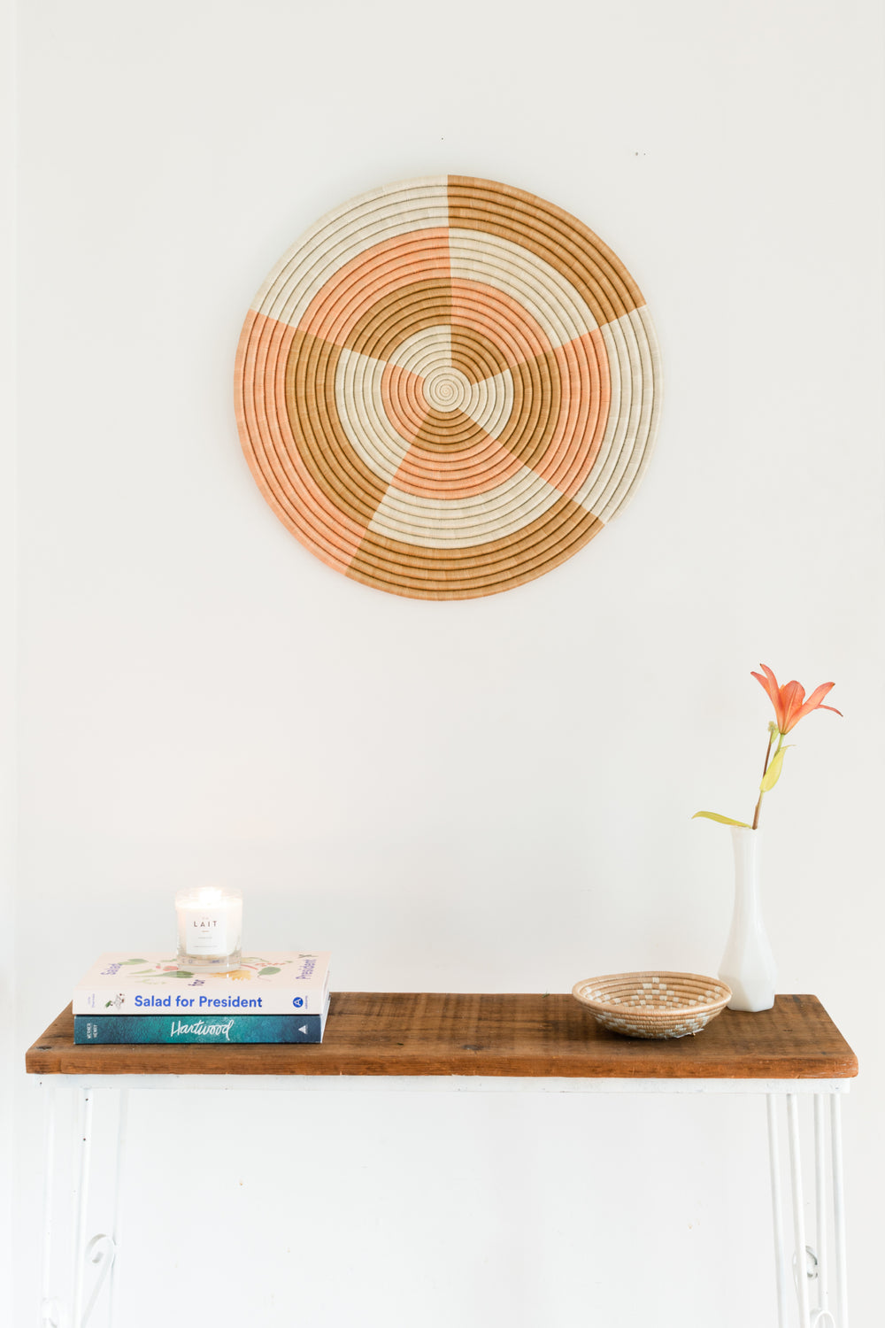 Round sisal flat woven wall hanging in natural fiber with a minimalist design.