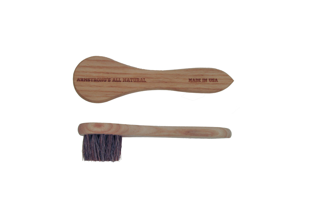 Natural horsehair dauber with soft bristles and a wooden handle for leather care.