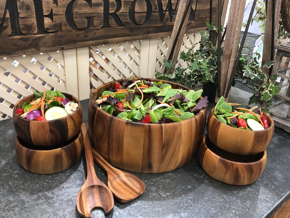 Dragor seven-piece acacia wood salad set with serving utensils and natural grain.