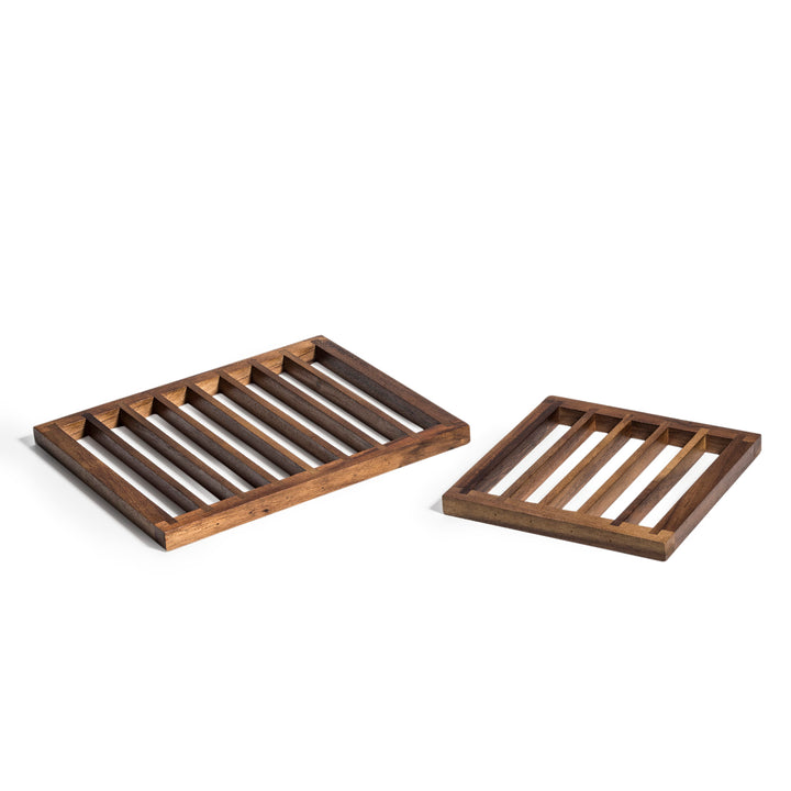 Set of acacia wood trivets with natural grain for protecting surfaces from heat.