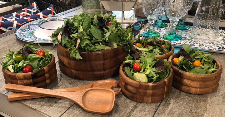 Skagen seven-piece acacia wood salad set with smooth, rounded bowls.