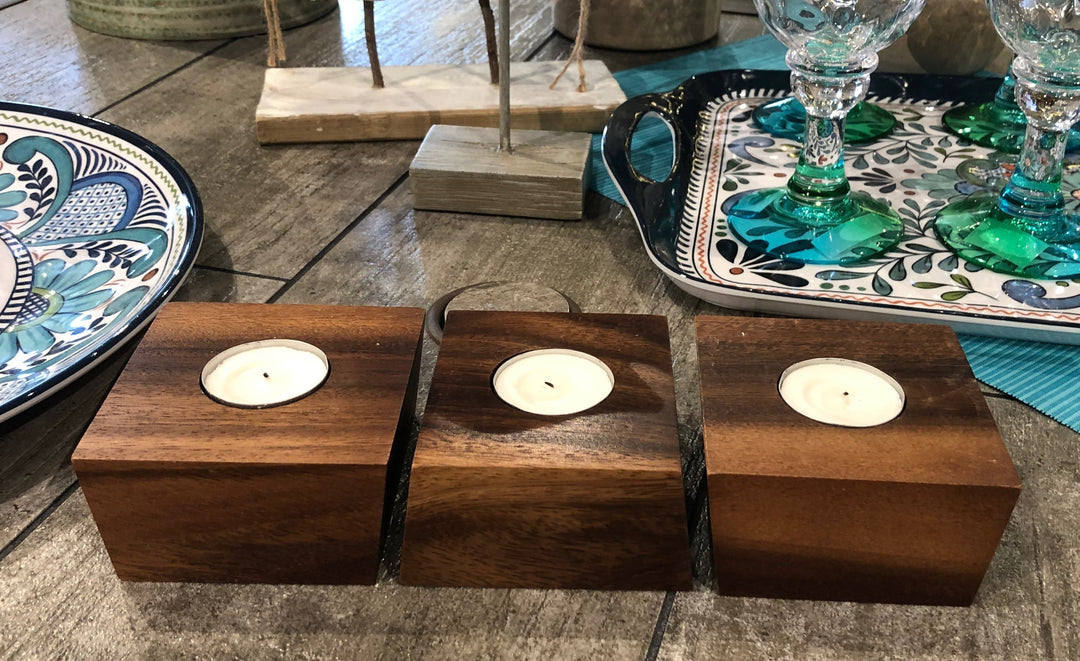 Acacia wood tealight candle holders with cups and a natural finish.