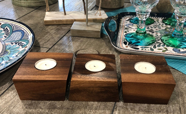Acacia wood tealight candle holders with cups and a natural finish.