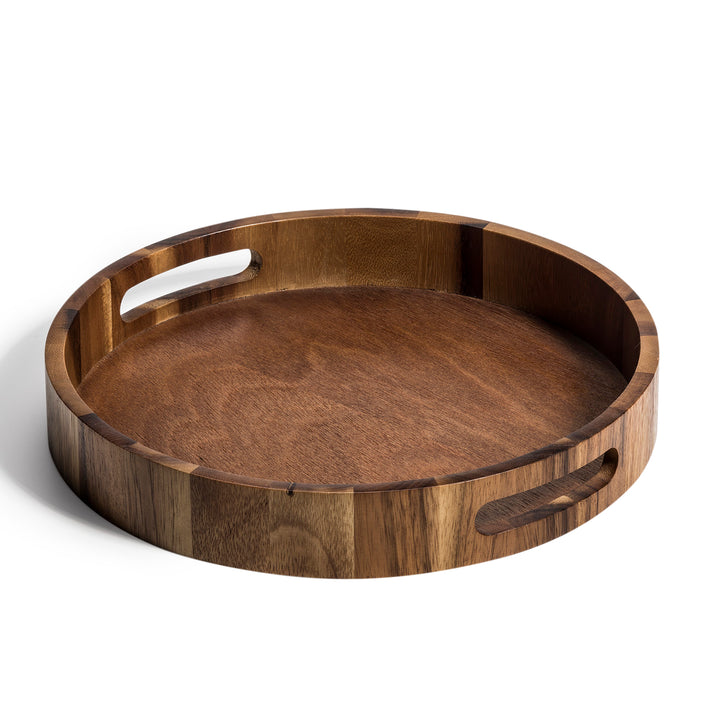 Round acacia wood serving tray with a smooth natural finish for serving.