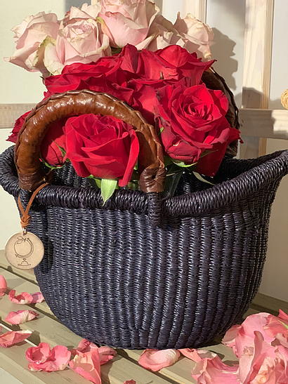 The Petite Victoria handwoven straw basket bag in natural woven straw.