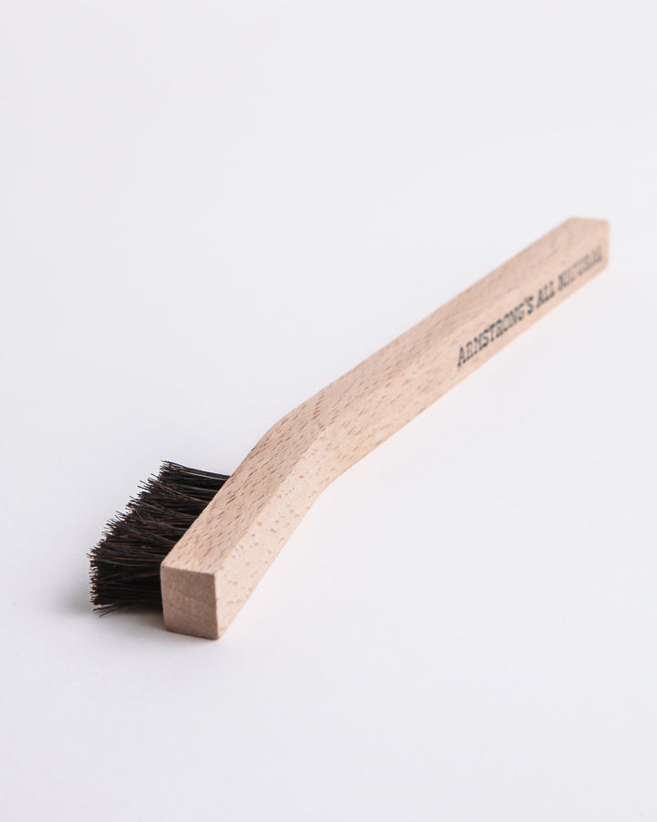 Small detail brush with natural bristles for precision cleaning.