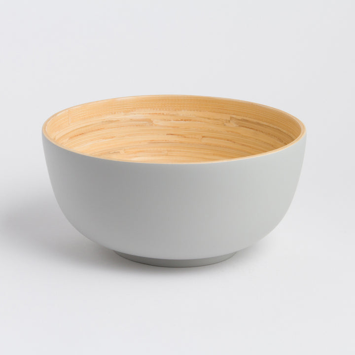 Large handcrafted bamboo salad bowl with a natural finish and rounded shape.