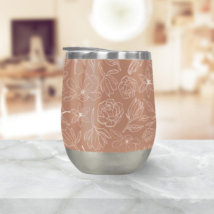Copper floral wine tumbler with press-on lid, white magnolia line-art on a terracotta body, and stainless base.