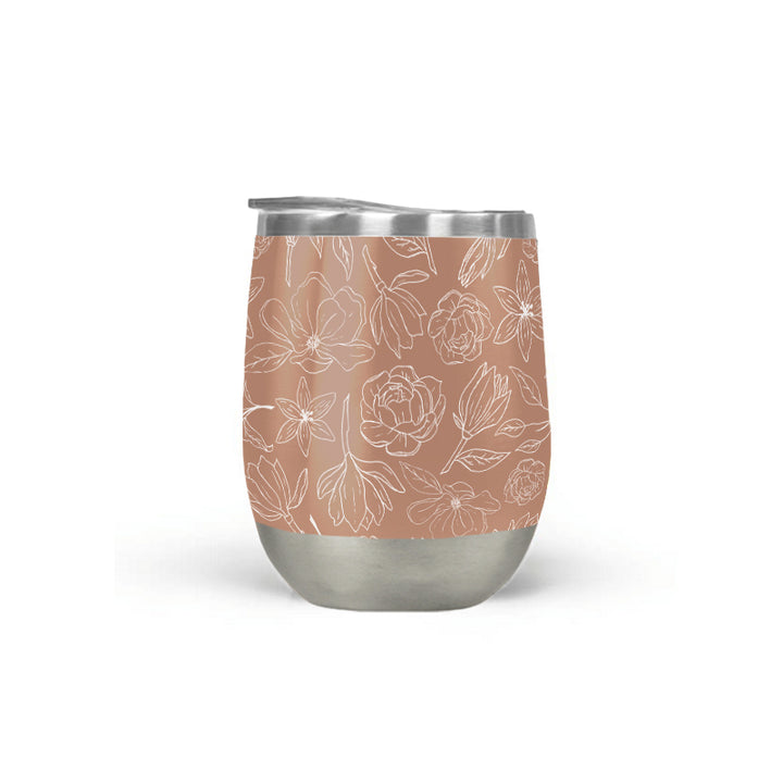 Copper Magnolia insulated wine tumbler with white line-art florals on a terracotta body and stainless steel base.