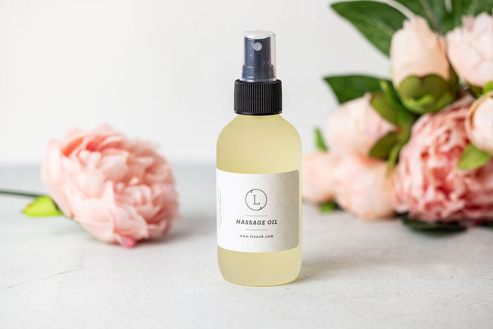 Eucalyptus massage oil in a glass bottle with eucalyptus leaves.