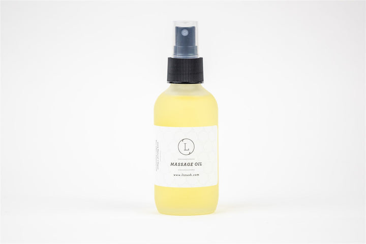 Lizush eucalyptus massage oil in a glass bottle with eucalyptus leaves.