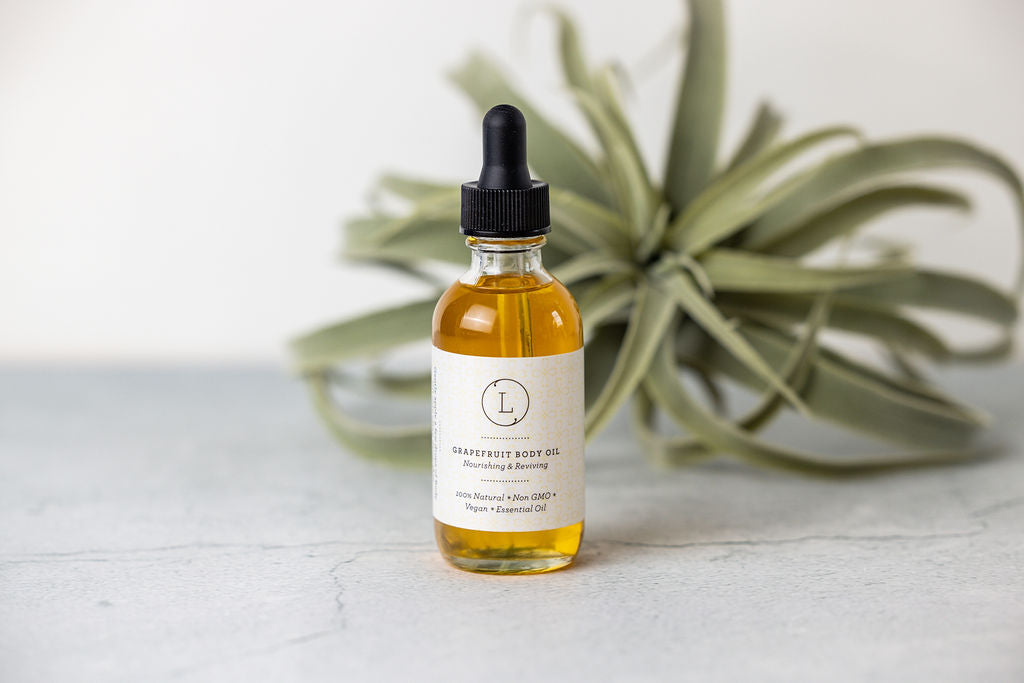 Grapefruit body oil with a citrus label, a moisturizing body oil.