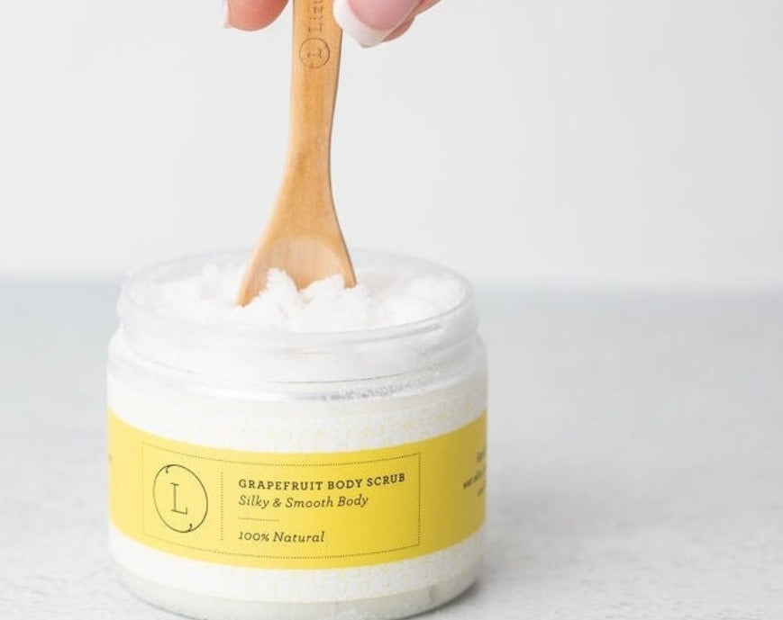 Grapefruit and shea butter body care set featuring a body scrub and body cream.