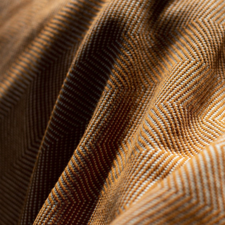 Close-up of the bronze herringbone weave in hand-spun cotton.