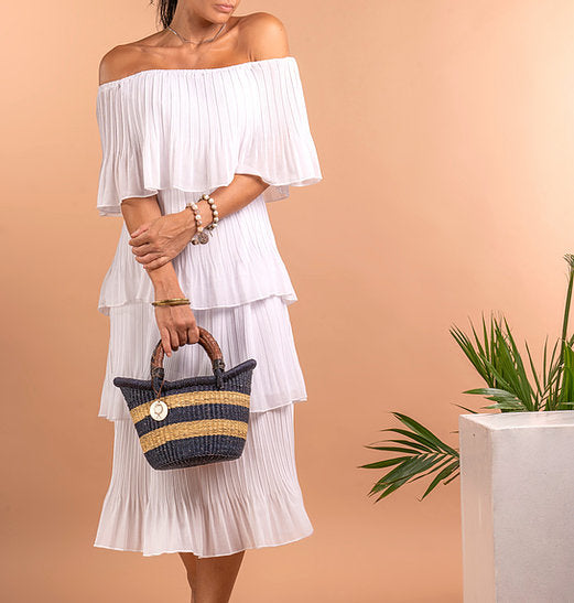 The Petite Victoria handwoven straw basket bag, showing its woven straw design.