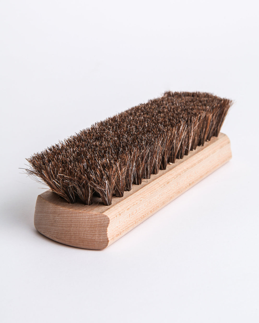 Natural horsehair buffing brush, handcrafted with a wooden handle and soft bristles.