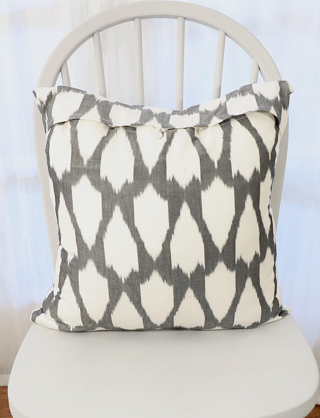 Handwoven black and white cotton throw pillow cover in neutral tones.