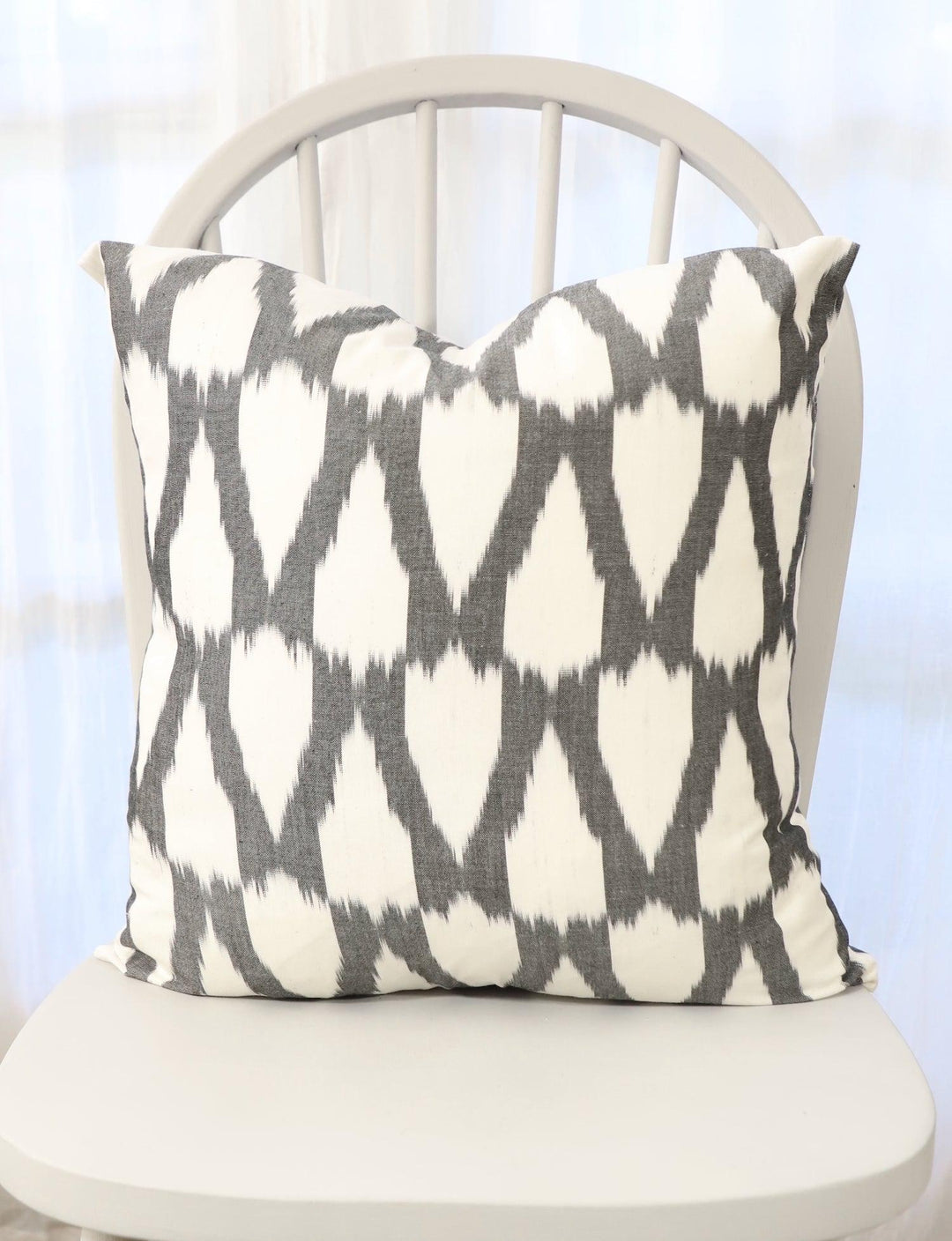 Handwoven black and white cotton throw pillow cover with a woven pattern.