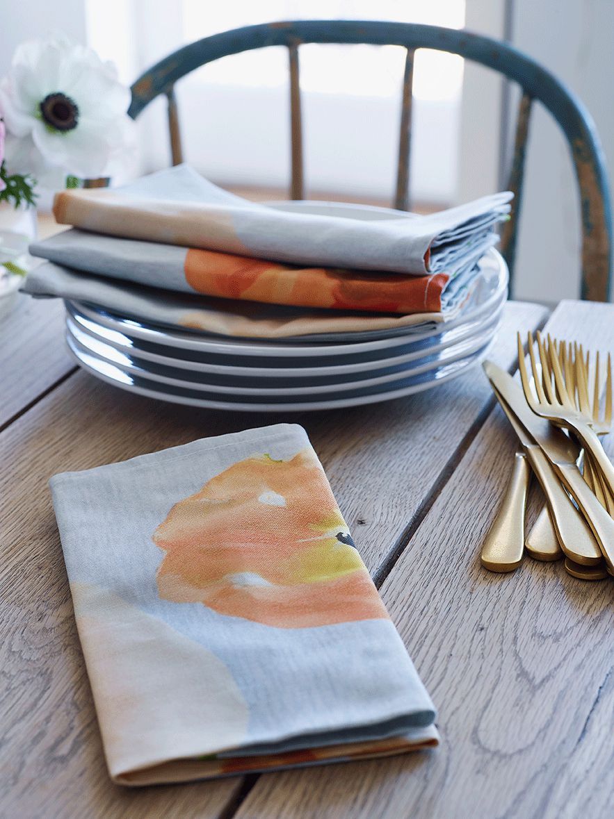 Peach poppy linen napkins, set of four, on a soft grey ground.