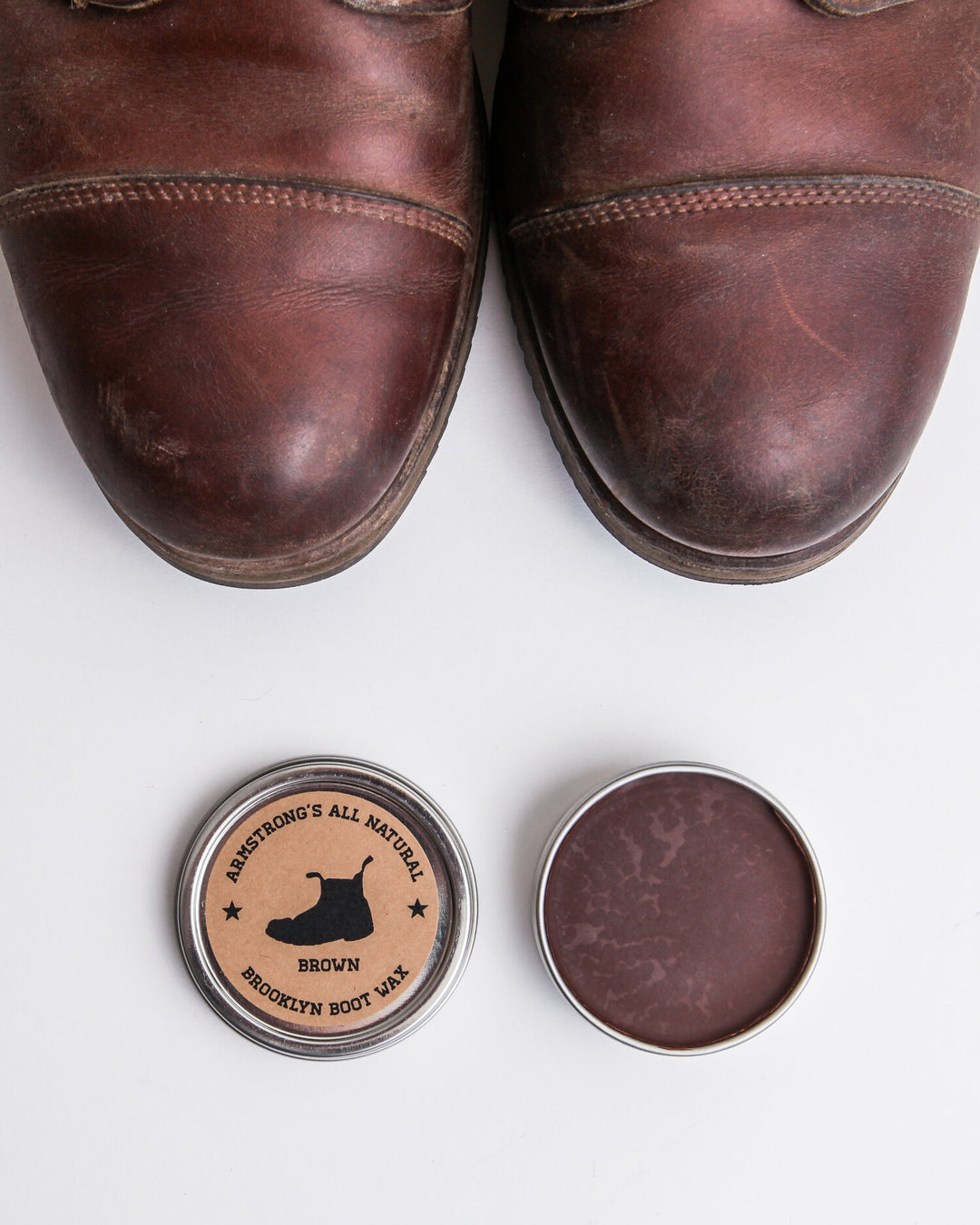 Brooklyn Boot Wax in pigmented black, a tin of black wax with a brush.