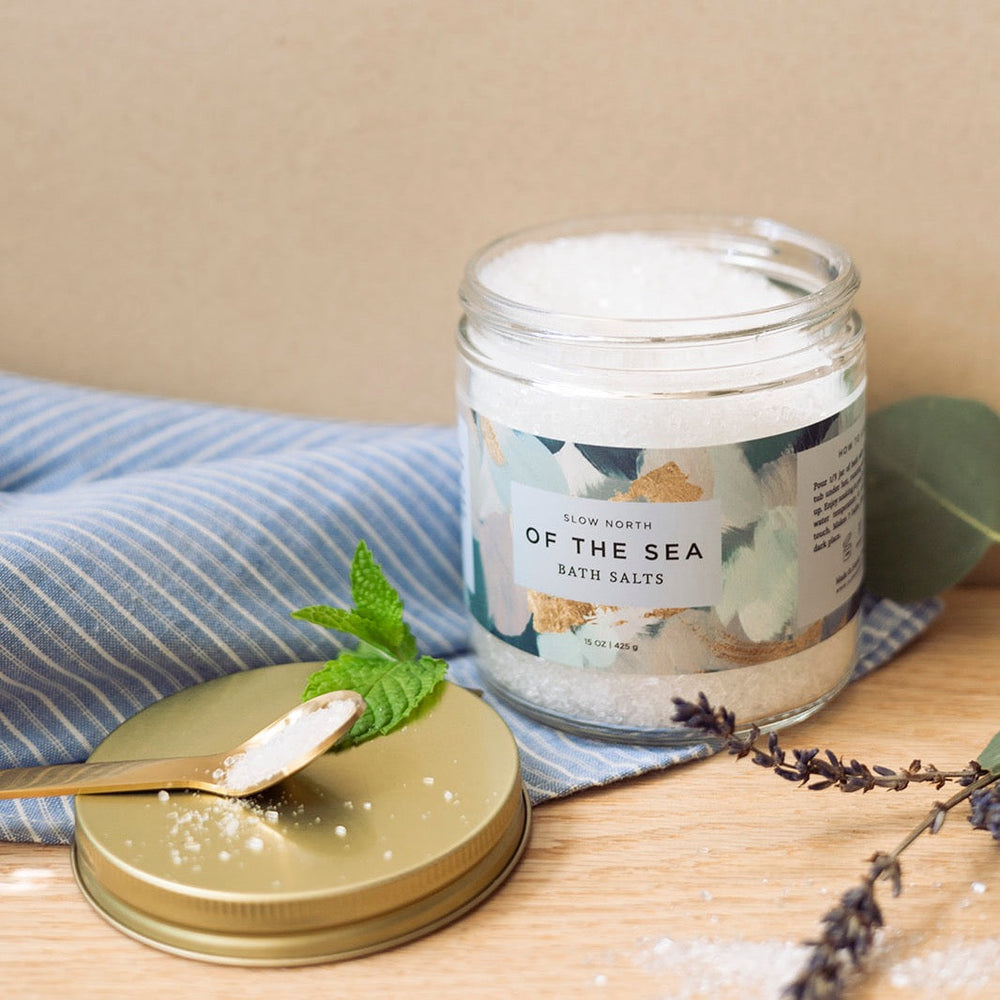 15 oz jar of bath salts with sea-inspired branding and natural minerals.