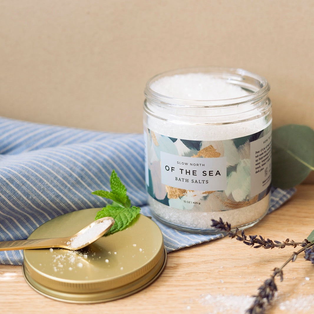 15 oz jar of bath salts with sea-inspired branding and natural minerals.