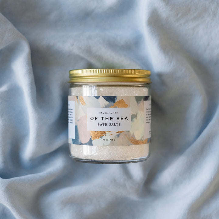 Coarse mineral bath salts with ocean-inspired packaging in a clear jar.