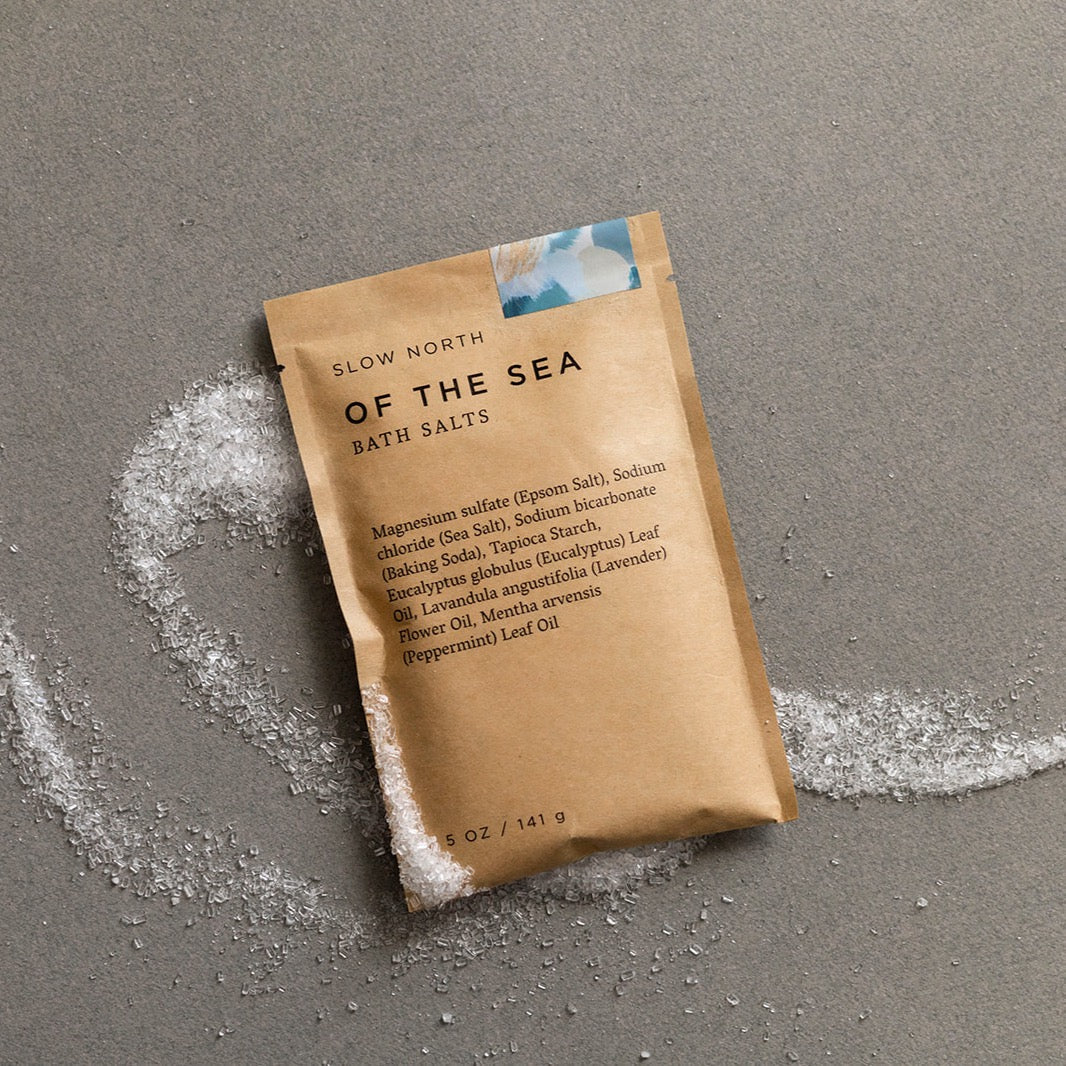 Kraft pouch of Of The Sea bath salts with eucalyptus and lavender essential oils visible through packaging.