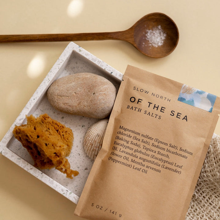Of The Sea bath salts shown in kraft pouch with botanical accents.