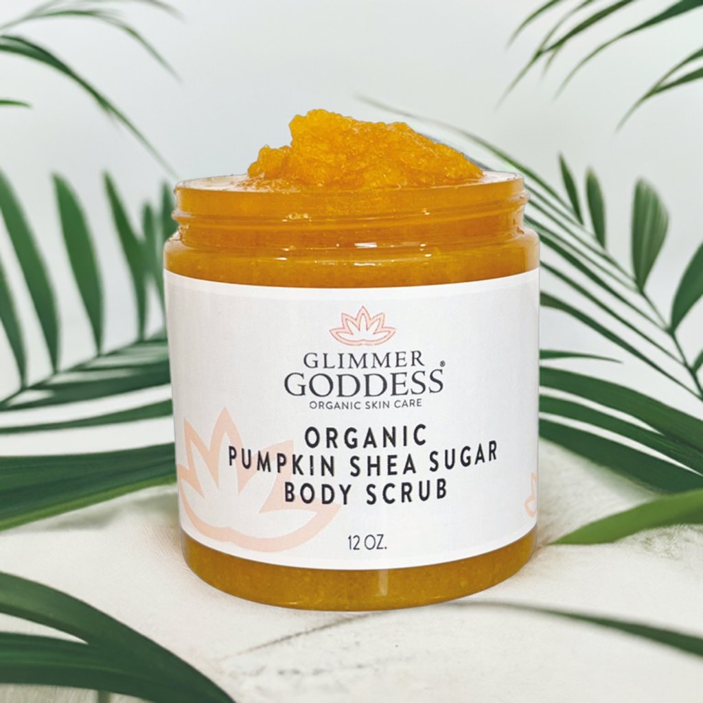 Organic pumpkin and shea butter body scrub with sugar in a clear jar.