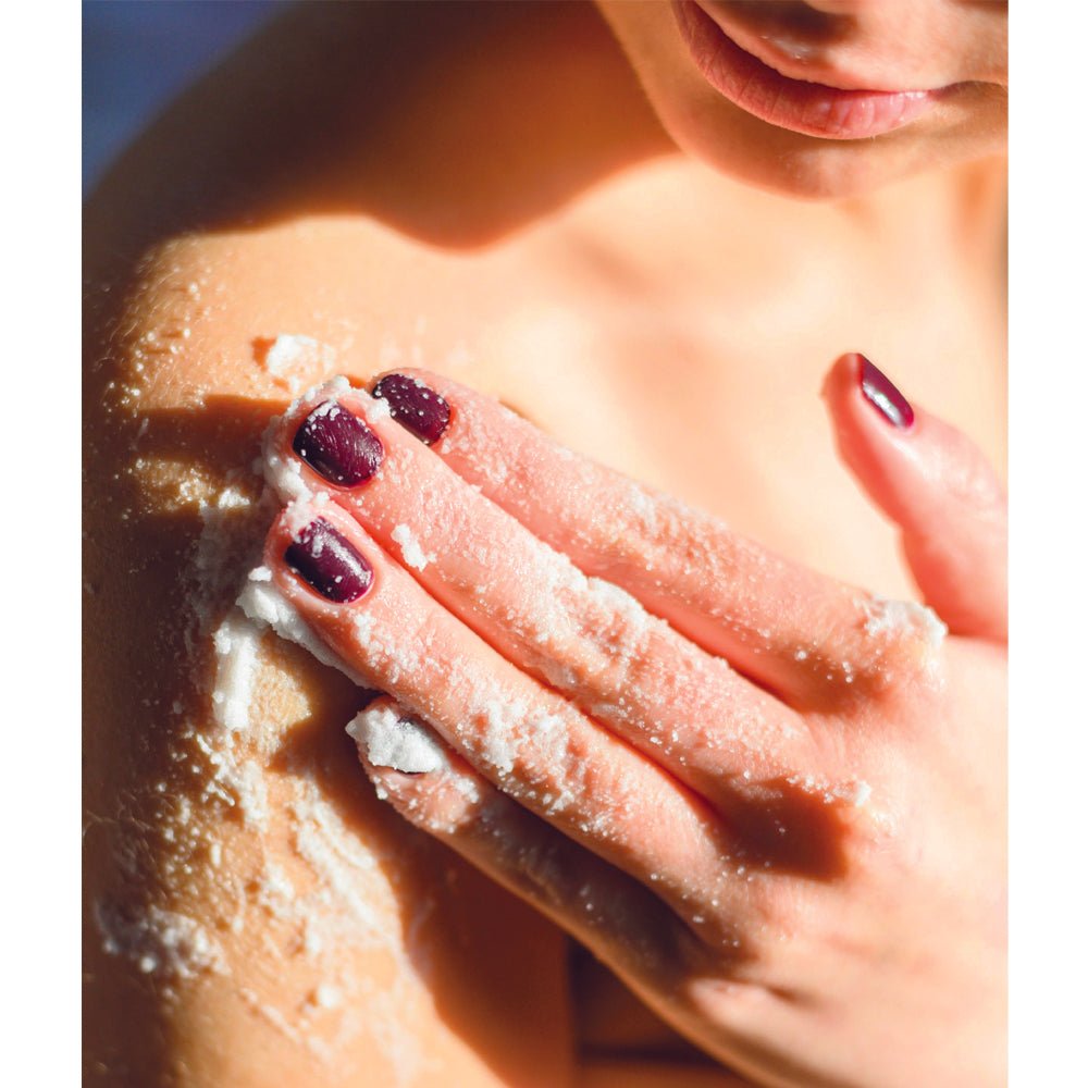 Organic whipped sugar body scrub with a smooth, fluffy texture in a jar.