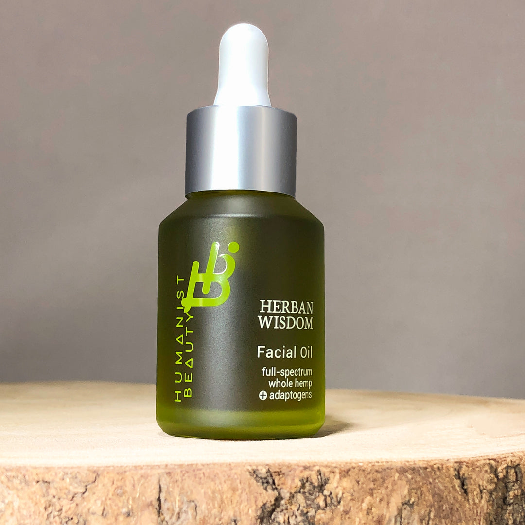Herban Wisdom facial oil in a glass bottle with a dropper.