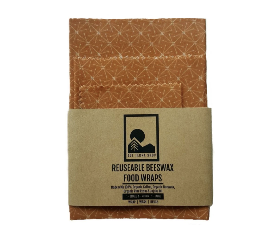 Reusable organic beeswax food wraps with colorful patterns on fabric.