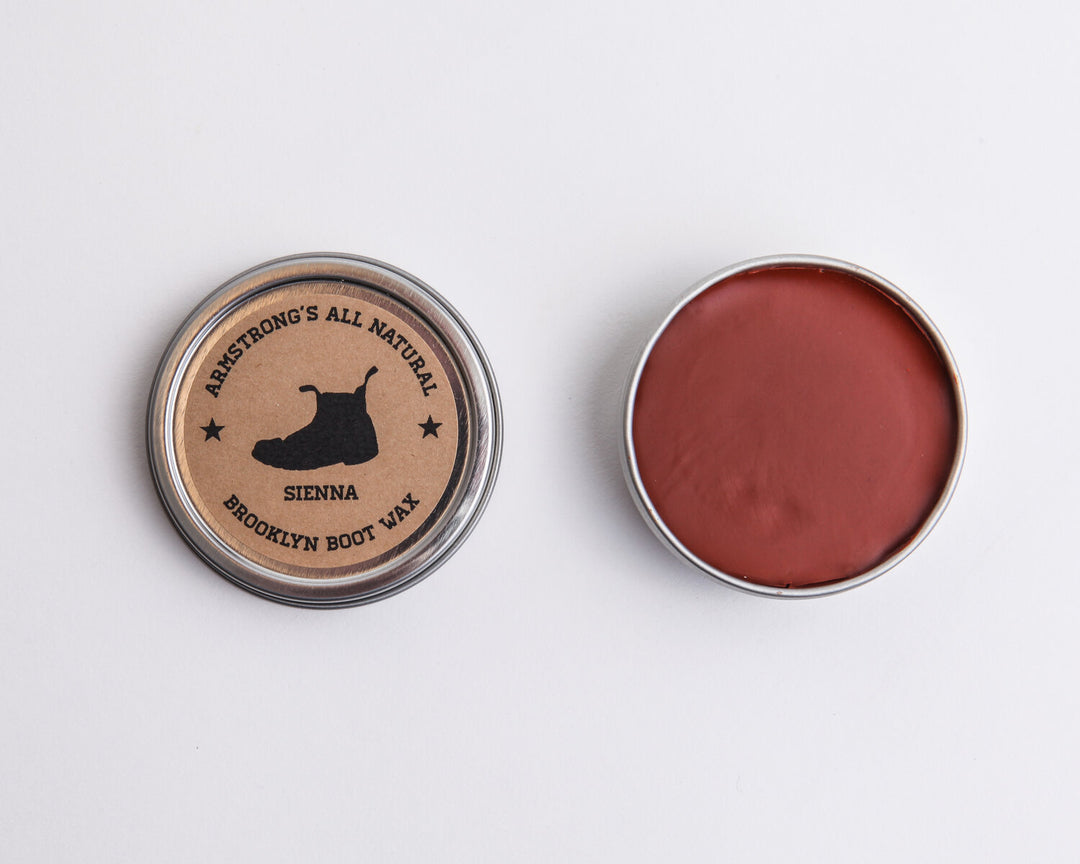 Brooklyn Boot Wax in pigmented black, a tin of black wax with a brush applicator.