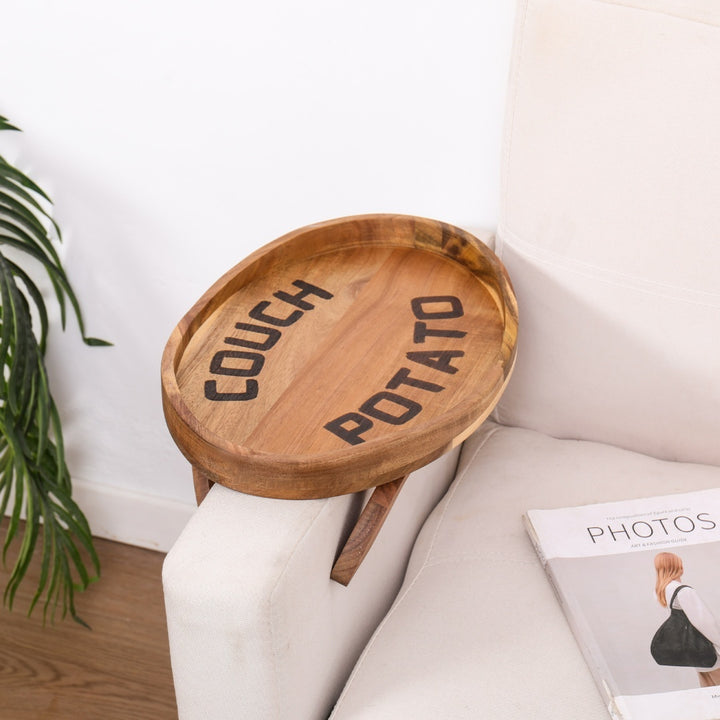 Acacia wood clip-on sofa tray that holds snacks and drinks on a sofa armrest.