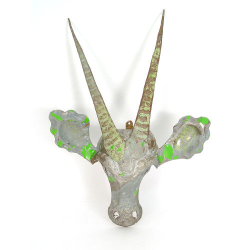 Side view of the recycled-metal sable antelope mask wall art.