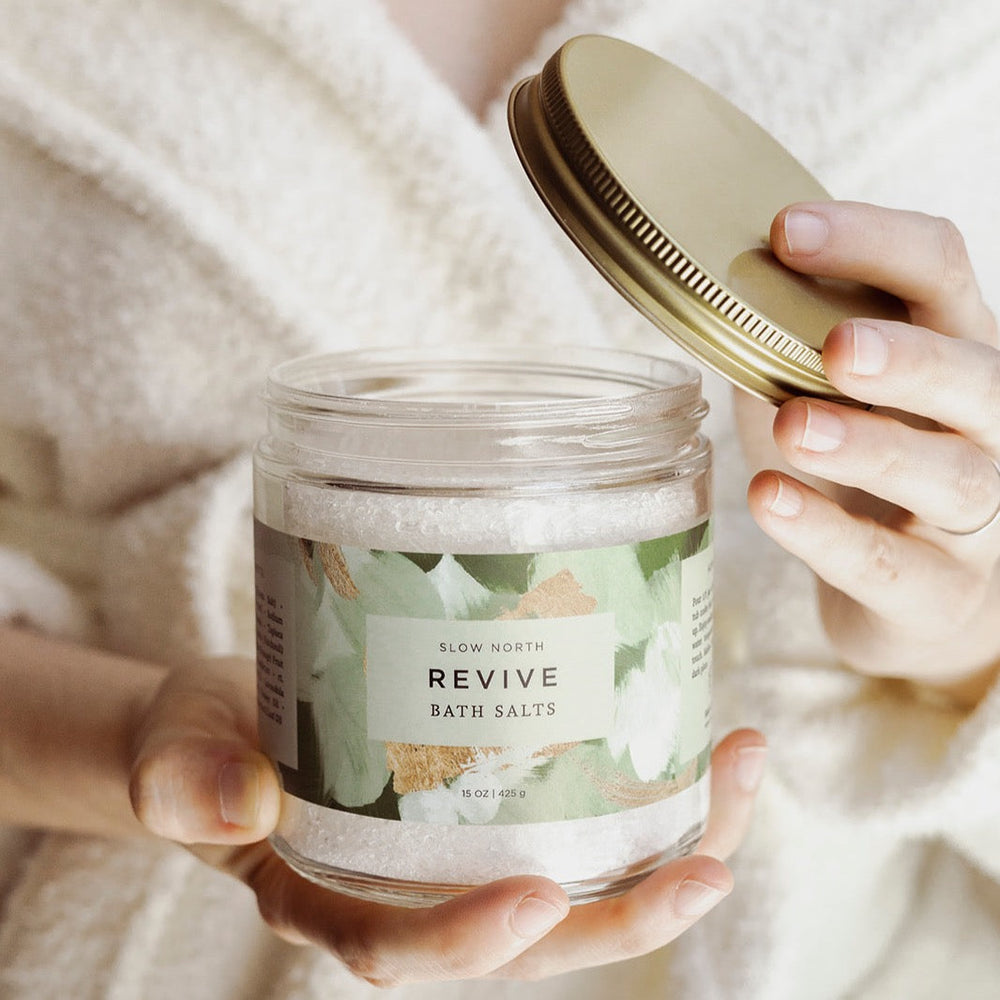 Revive bath salts in a clear glass jar showing the salt and essential oil blend.