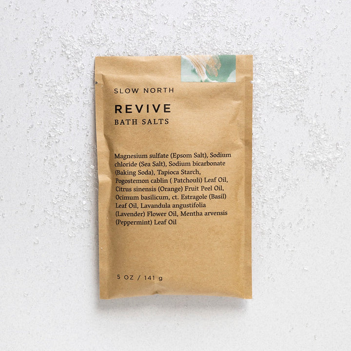 Bath salts with colorful crystals visible through transparent pouch window.
